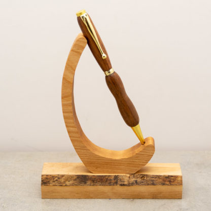 This Funline ball point pen has a custom wood turned barrel with metal hardware. The finish on the wood shows the natural wood grain and color. This light weight pen is ideal for every day use and uses a standard Cross Style refill when you run low on ink.