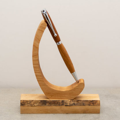 This Funline ball point pen has a custom wood turned barrel with metal hardware. The finish on the wood shows the natural wood grain and color. This light weight pen is ideal for every day use and uses a standard Cross Style refill when you run low on ink.